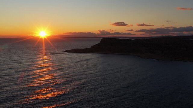 Aerial drone view of the Mediterranean Sea at sunset near Limassol, Cyprus, with calm water and distant coastline