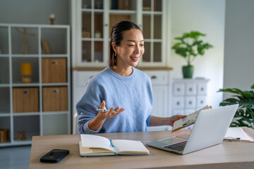 Obraz premium Asian woman working remotely on video call