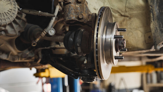 Car suspension and disc brake system undergoing maintenance in Moscow auto repair shop