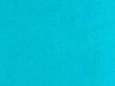 Superficie de papel granulado en color azul cian vibrante con textura de fibra