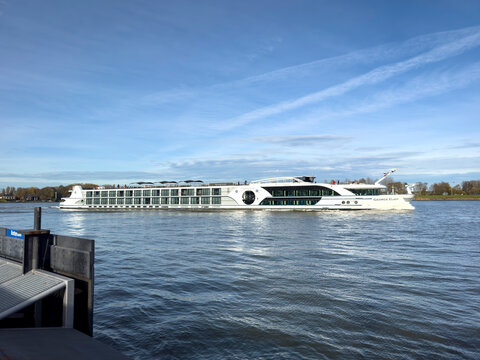 Dordrecht, Netherlands - 12 November 2025: Elegant five-star river cruise ship MS George Eliot passing the historic city of Dordrecht in the Netherlands, luxury travel along European inland waterways.