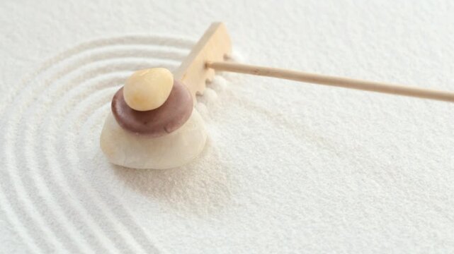 Making zen garden with stones and white sand
