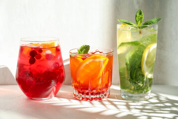 Fototapeta premium Different tasty refreshing cocktails on light table