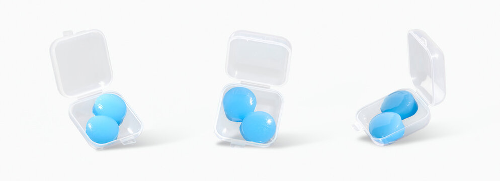 Reusable silicone earplugs in storage cases on light background. Concept of noise reduction, eco-friendly hearing protection, sustainable portable solution for sleep, travel and noisy environments