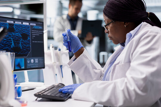 Scientist analyzing tissue in flasks for a bio science study, using chemistry tools in laboratory. Working in biotechnology, medical research and healthcare technology for discovery.
