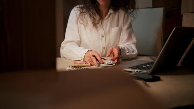 Woman Handling Bills And Spreadsheets, Woman Meticulously Preparing Tax And Budget Paperwork At Her Desk