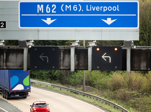 Diversion on the M62 motorway from Manchester to Liverpool with the matrix warning signs showing keep left arrows. 