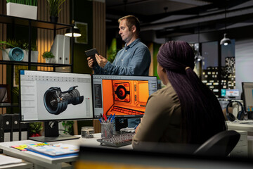 Team works with AI game hub and turbine to develop a futuristic spaceship station. Neural network powered software uses automation and machine learning to generate game environments and tools. © DC Studio
