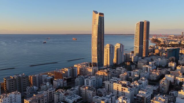 Aerial drone view of Limassol coastline with high rise buildings and sea in the background