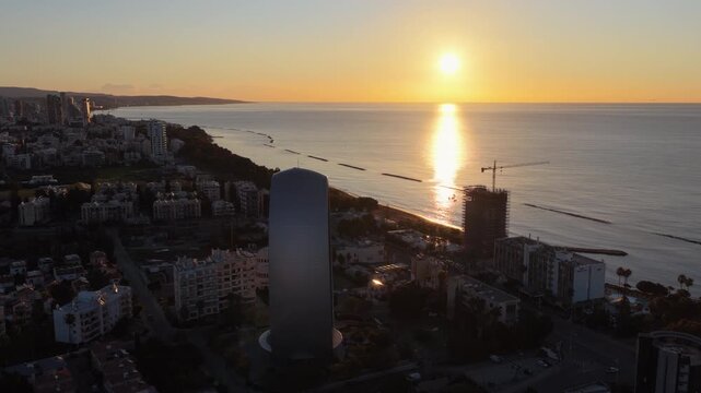 Aerial drone view of Limassol skyline featuring modern architecture and dense urban layout at golden hour