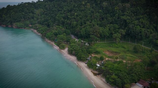 Aerial drone view of tropical beach, turquoise sea and lush green forest in Thailand. Stunning natural coastal landscape, untouched paradise with clear water and scenic shoreline.