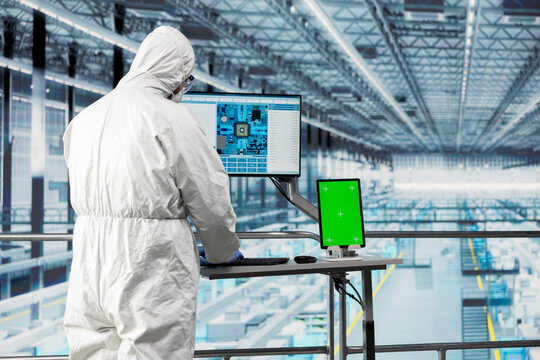 Isolated screen tablet used by QC engineer designing microchip layout with EDA app in industry 4.0 plant. Employee reviews automated semiconductors smart factory schematics with chroma key device