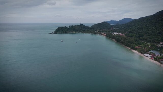 Aerial drone view of tropical beach, turquoise sea and lush green forest in Thailand. Stunning natural coastal landscape, untouched paradise with clear water and scenic shoreline.