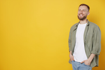 Fototapeta premium Portrait of handsome man on orange background, space for text