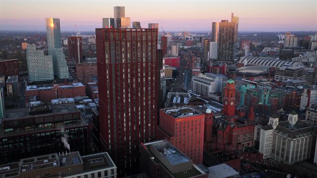 Aerial video of golden sunrise over Manchester, featuring Oxford Road Station and the towering skyscrapers of Deansgate Square and New Jackson. 