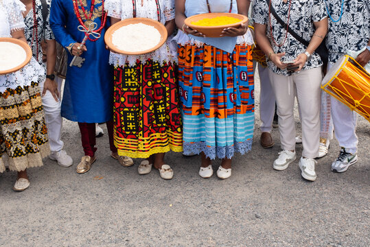 Devotees wearing traditional Candomble clothing and carrying traditional objects.