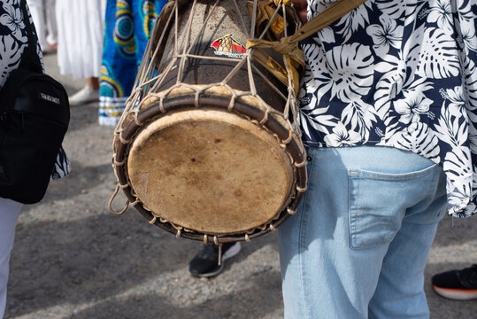 Musician playing atabaque in procession
