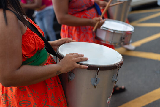 Dida, an all female percussion band, performs in a parade.