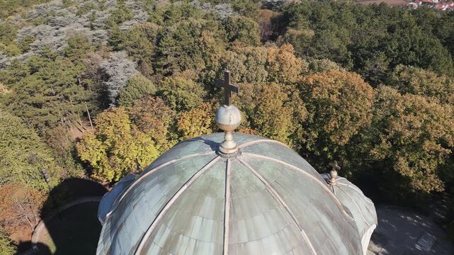 Orbiting drone video showcases a close view of the golden cross atop the Saint George church dome in Oplenac, Serbia.