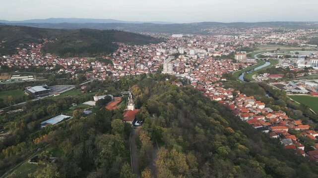 Aerial backward drone movement revealing Prokuplje town panorama in southern Serbia.