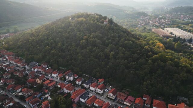 Drone shot of the lush green woods on Hisar hill under bright sun in Prokuplje, southern Serbia.