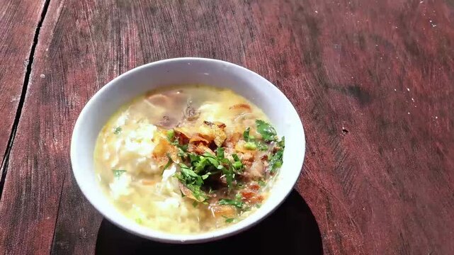 Beef Soto on Wooden Table &ndash; Traditional Indonesian Soup Dish