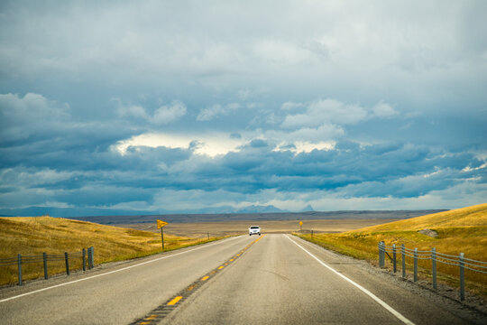 USA, Montana.  Automobile traveling on a lonely stretch of State Route 89 near the Alberta border.
