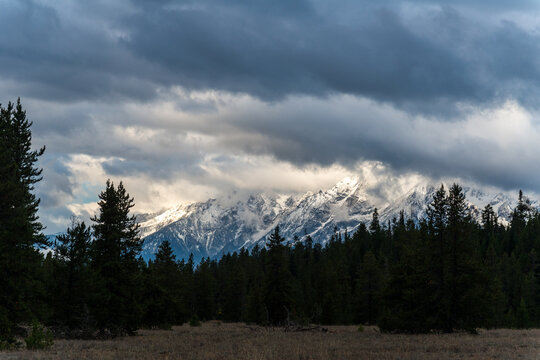 USA, Wyoming, Grand Teton National Park.  A glimpse of the Grand Tetons through the clouds on a stormy day.