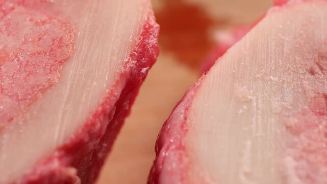Close up video showcasing raw beef bones cut in half, revealing bone marrow detail.