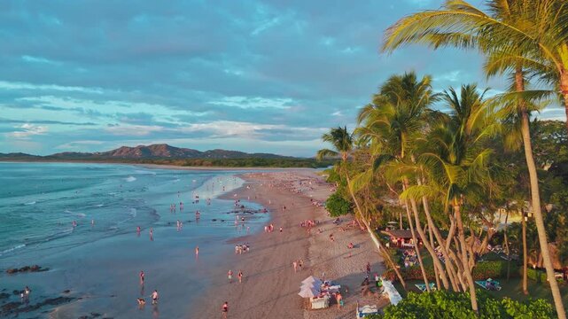 Tamarind Costa Rica aerial view of Playa Tamarindo in the afternoon with palm trees and tourists on the beach