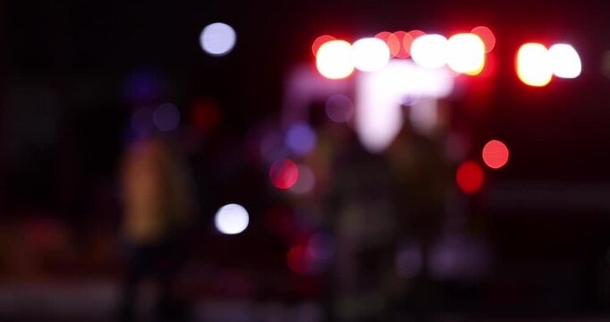 Abstracted view of firefighters loading a person into the back of an ambulance.