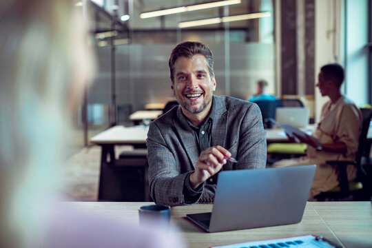 Smiling manager interviewing candidate in modern office