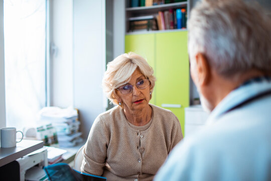 Senior woman consulting doctor in medical clinic
