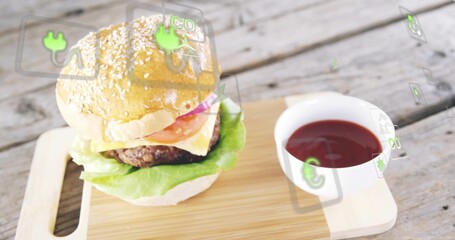 Displaying sesame burger resting on wood board with cheese, ketchup bowl and AR icons, copy space © vectorfusionart