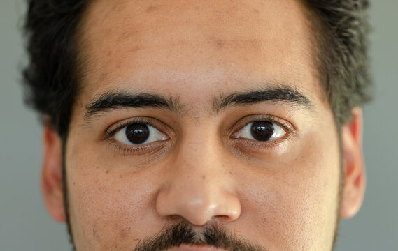 African American adult male looking directly at camera in studio, showing detailed facial texture