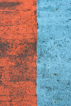 Close-up of a sidewalk painted red and blue in Japan.