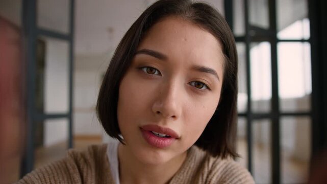 POV webcam Hispanic woman at home using smartphone touchscreen scrolling photo point of view Latino female user girl influencer addicted mobile phone typing screen display sliding fingers enlarge zoom