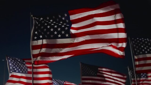 USA flag close detail waving at night in Malibu, California, USA under strong lighting creating cinematic patriotic and emotional remembrance scene