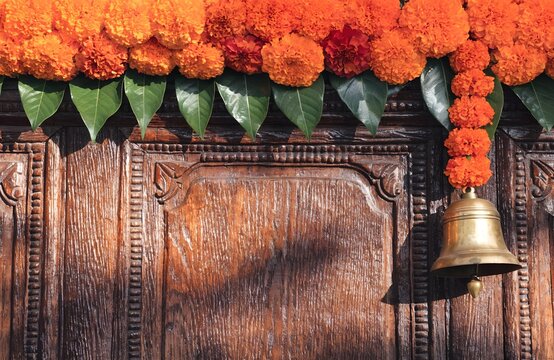 Traditional Indian wooden background with marigold toran and copy space