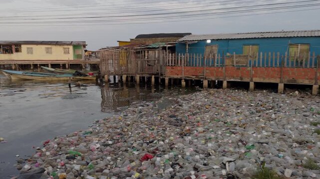 Plastic waste along stilt houses on Lake Maracaibo, Venezuela