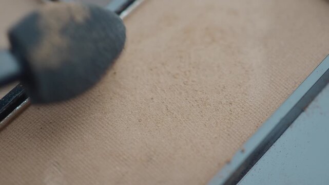 Applying makeup with a brush on a makeup palette