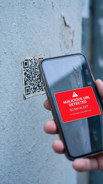 Scam alert ai cybersecurity warning phishing smishing phone scanning qr code with malicious url detected message on screen for safety