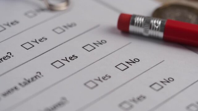 Survey response with completed checkboxes and pen