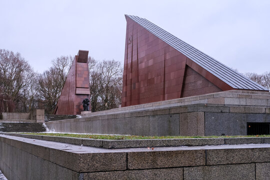Berlin, Germany &ndash; View of the red granite monuments at Treptower Park, designed as stylized lowered flags to honor the millions of Soviet soldiers who died during WWII.