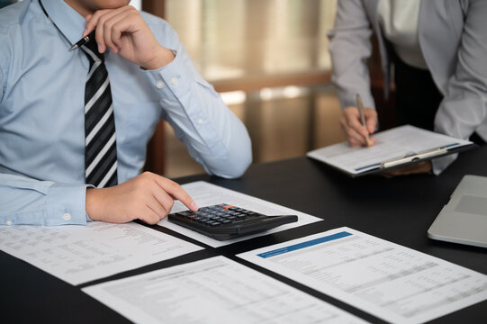 Finance and accountant team working in office for accounting and preparation services for financial statements and cash flow with analyze data insight for finance and taxation planning.