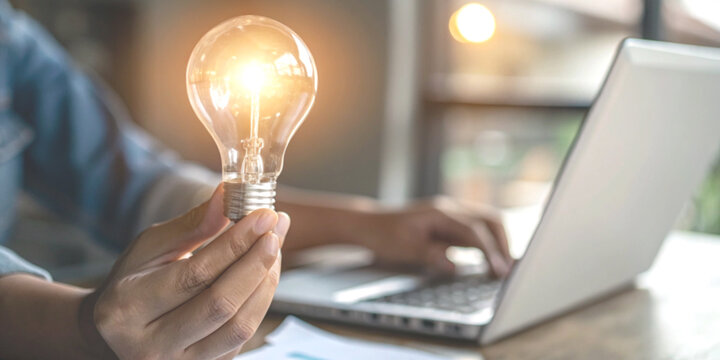Business and investment ideas with hands holding a light bulb in startup business concepts and creativity.