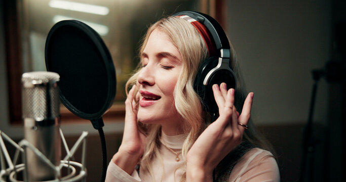 Singer, microphone and person in studio with headphones, production or musician in performance. Talent, music recording or artist in booth with tech, song or sound entertainment for creative album.