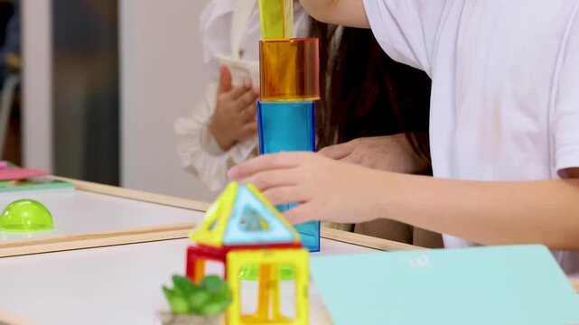 Children Building Colorful Block Tower in Classroom Activity