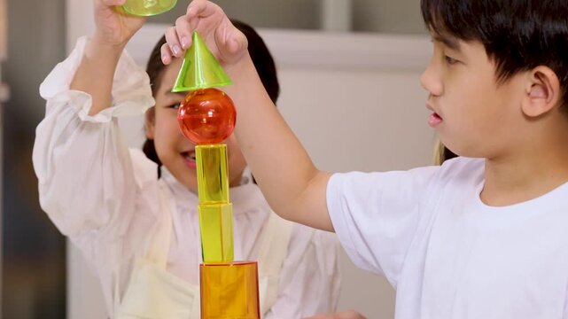 Children Collaborating to Build Colorful Block Tower in Classroom