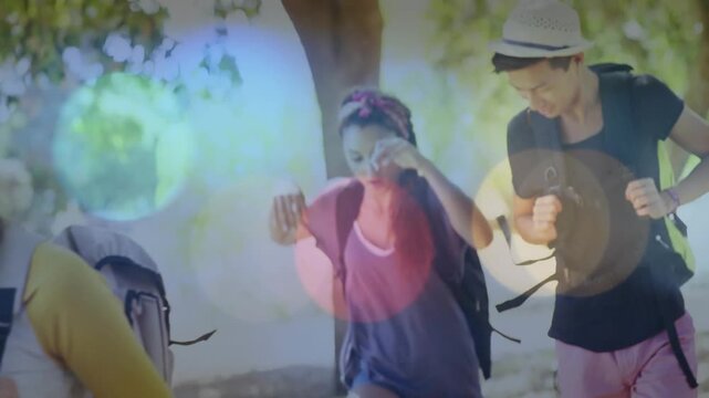 4 hikers walking trail woman tugging causing fedora man leaning in steadying bokeh framing travel